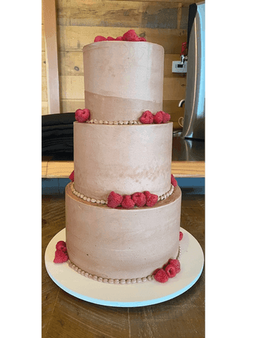 Two-tier white cake with blush pink blooms