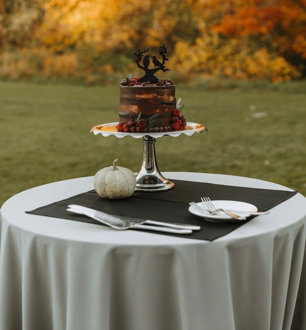 Chocolate celebration cake on a footed cake stand