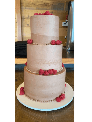 Blush tiered wedding cake with sugar roses