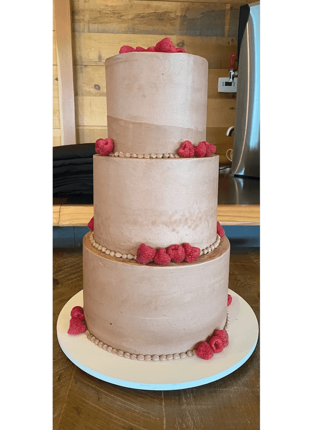Blush layered wedding cake with soft floral detail