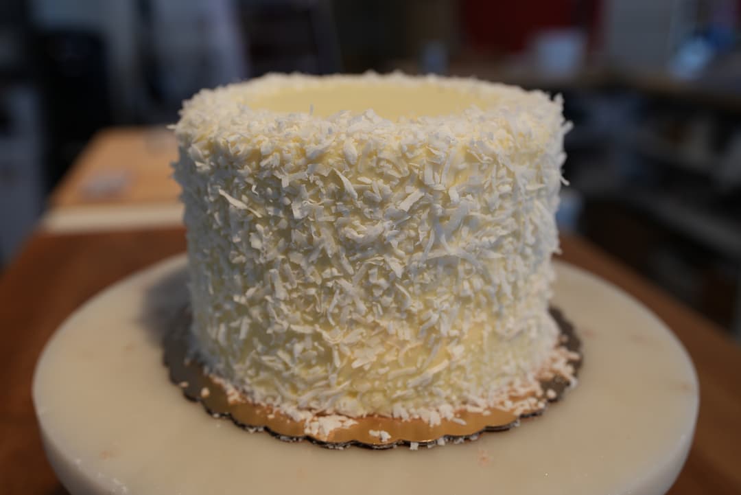 Carrot cake layered with cream cheese frosting and toasted coconut