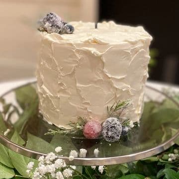 Textured white wedding cake with delicate floral sprigs